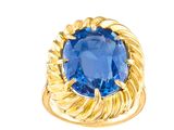 a close up of a gold ring with a blue stone