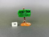 a small sign that says griss town next to a small sign