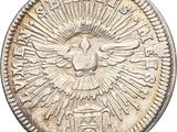 an old silver coin with a bird on top of it