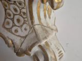 a close up of a vase with a gold decoration on it