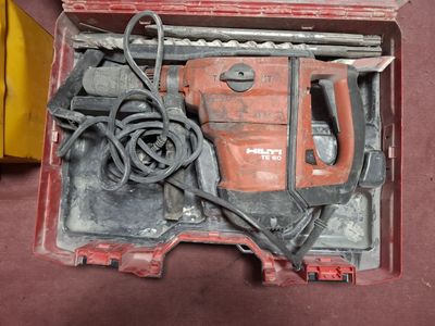 a red tool box with tools in it on the floor