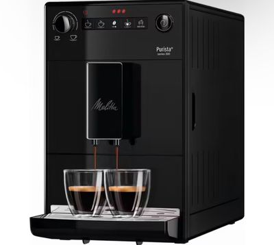 a black coffee machine with two cups of coffee on it