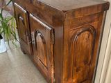 a wooden cabinet with a mirror on top of it