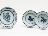 three blue and white plates with floral designs on them on a white surface