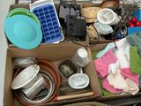 a box full of dirty dishes and dishes on the floor