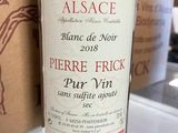 a bottle of wine sitting on a counter next to a box
