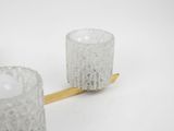 a toothbrush sitting next to a glass cup on a table