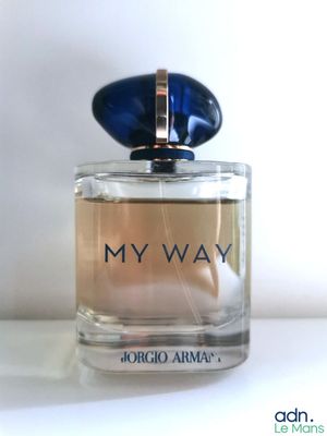une photo d'un flacon de parfum posé sur une table