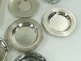 a lot of silver plates on a white table