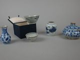 four different types of blue and white vases on the table