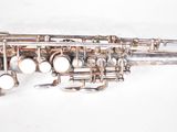 an old silver plated saxophone with a silver bell on a white background