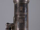 a close up view of a silver plated instrument on a table