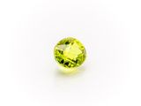 a yellow sapphire stone on a white background