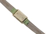 a close up of a wrist watch with a green strap