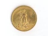 a gold coin on a white surface with a white background