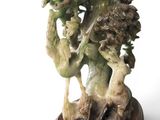 a statue of a man riding a horse on a wooden base