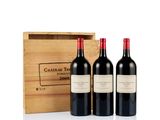 three bottles of red wine in front of a wooden box