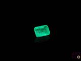 a green emerald stone lit up in the dark