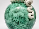 a green vase with a spiral design on it
