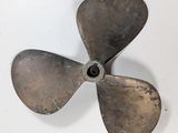 an old propeller propeller on a white surface with a small hole in the center