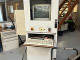 a computer sitting on top of a machine in a room