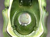 a green bowl that has a hole in the middle of it