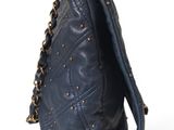 the back of a blue purse with a chain hanging from it