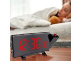 a clock that is sitting on a table next to a teddy bear