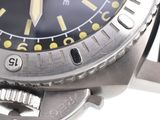 a close up of a watch on a white surface