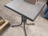 a small table with a box on it in the middle of a room
