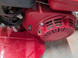 a close up view of a red engine and a red gas can