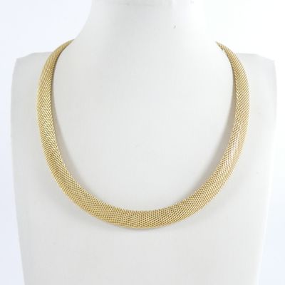 a close up of a gold necklace on a mannequin mannequin