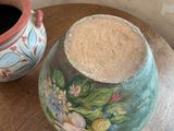 two vases sitting on a table next to each other