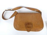 brown leather purse on white background with leather strap