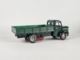 a green toy truck with a green trailer on the back of it