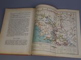 an open book with a map on it on a table