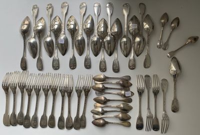 a lot of spoons and forks laid out on the table