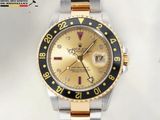 a gold and black rolex watch sitting on a white surface