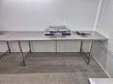 a long table with a bunch of electronic equipment on top of it