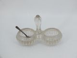 a small glass bowl with a spoon in it on a white surface