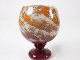 a glass vase with a red base on a white background