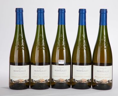 four bottles of wine are lined up on a white surface