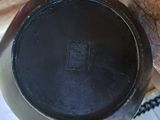 a black pot sitting on top of a wooden table