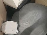 a large gray ball sitting in the middle of a cardboard box