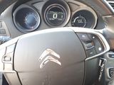 the interior of a car with a steering wheel and dashboard controls