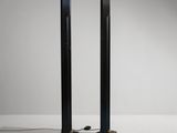 a pair of black speakers sitting on top of a white floor