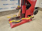 a red machine that is sitting on the ground