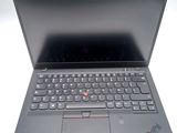the laptop is open on a white surface with a black keyboard