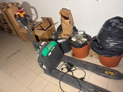 a pallet with a fork and a bag on it in a room