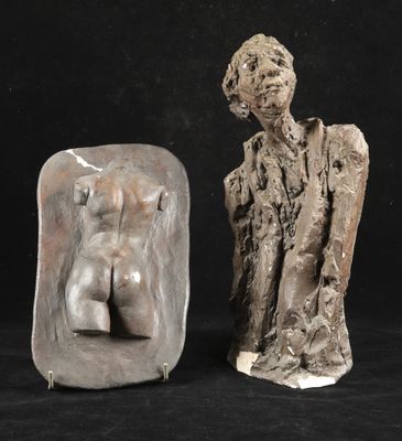 two sculptures of a man and a woman on a black background